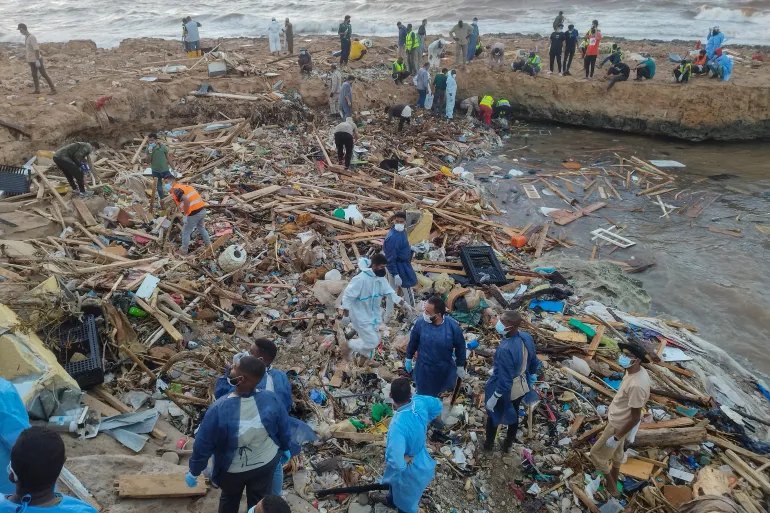 Rescuers and relatives search for bodies of the flood victims at the Corniche of the city of Derna [Abdulaziz Almnsori/AP Photo]