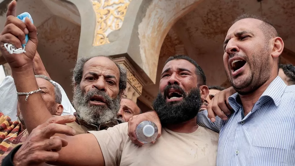 Protesters chanted and cried outside Sahaba Mosque on Monday